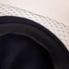 McBurn Baske aus Wollfilz mit Schleier McBurn Baske aus Wollfilz mit Schleier